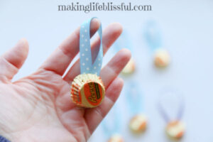 hand holding a olympic medal treat